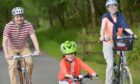 A family enjoying a cycle route in the Highlands.