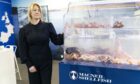 Amber Knight, of MacNeil Seafoods, with a tank of live crustaceans at Seafood Expo Global in Barcelona.