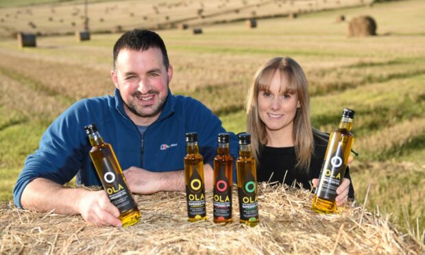 James and Chloe Ogg with some of their Ola Oil bottles.