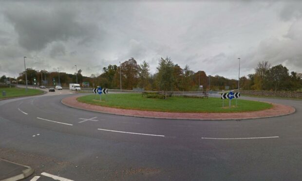 Police were called to the Spey Bay roundabout at Fochabers after the dog fell from a car. Photo: Google Maps