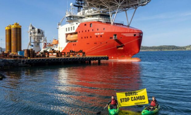 Greenpeace Norway activists in kayaks confront Siem Day loading drilling infrastructure for the Cambo oil field on behalf of Siccar Point Energy and Shell Oil outside Stavanger, Norway.