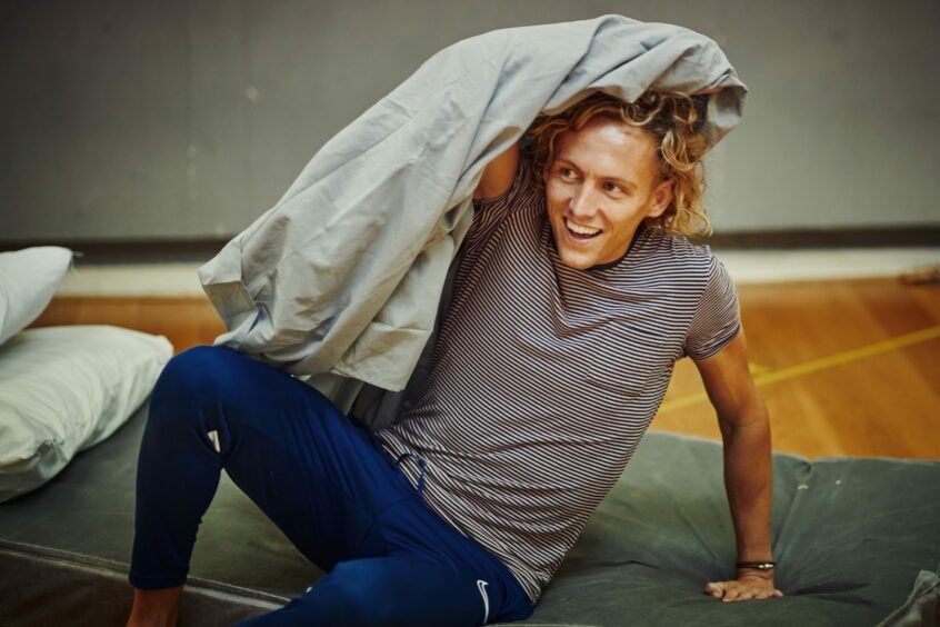 Glenn Adamson covering his head with a sheet during rehearsals for Bat Out of Hell The Musical. 