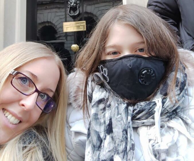 Helen Goss with her daughter Anna outside 10 Downing Street in London.