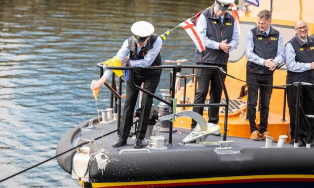 Christening the new lifeboat with Irn-Bru. Picture by Paul Campbell.