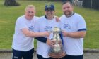 Invergordon manager Gary Campbell, assistant Ali MacGregor and player/coach Shaun Kerr holding a trophy for the North Caledonian league win