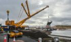 The work on the new Lossiemouth East Beach Bridge was delayed today - because the crane wasn't quite long enough. Pictures by JASON HEDGES/DCT Media