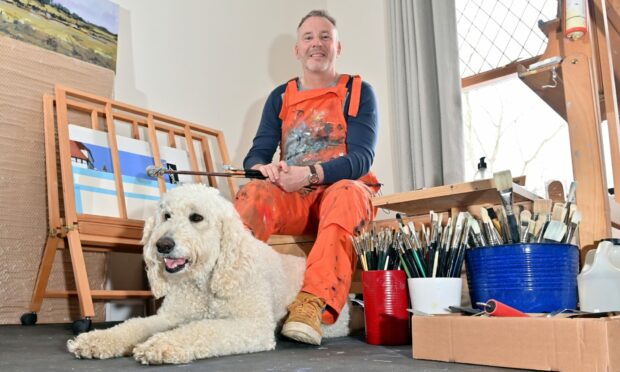 Picture shows: John O'Neill sat with his dog, Tanzie, in his art studio.