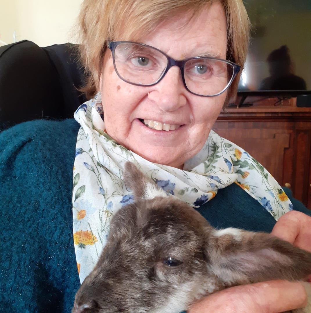 Mary Ross cuddling a lamb during an activity day at Leuchie House.