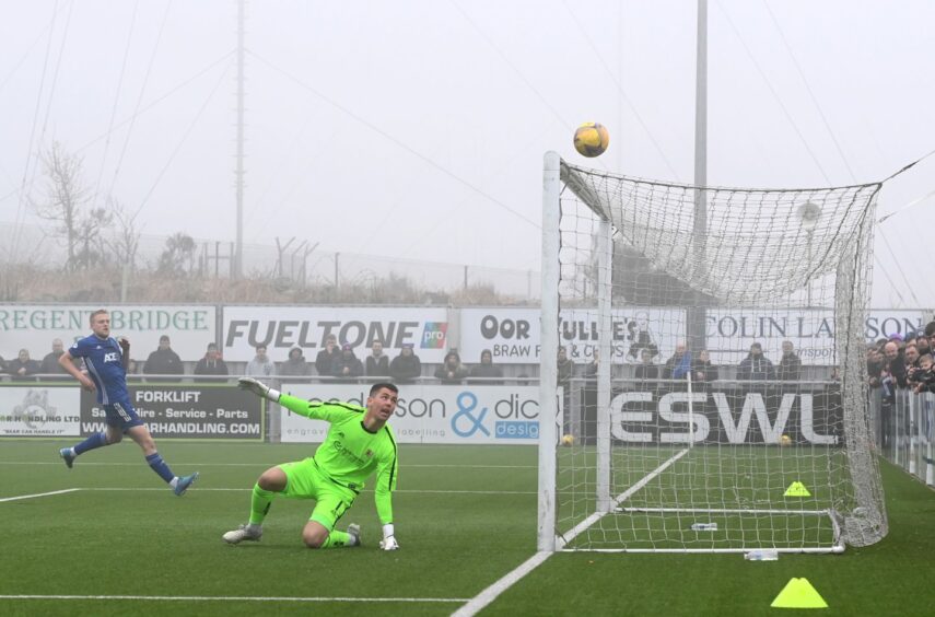Peter Morrison watches on as the ball drifts over the crossbar. Picture by Paul Glendell