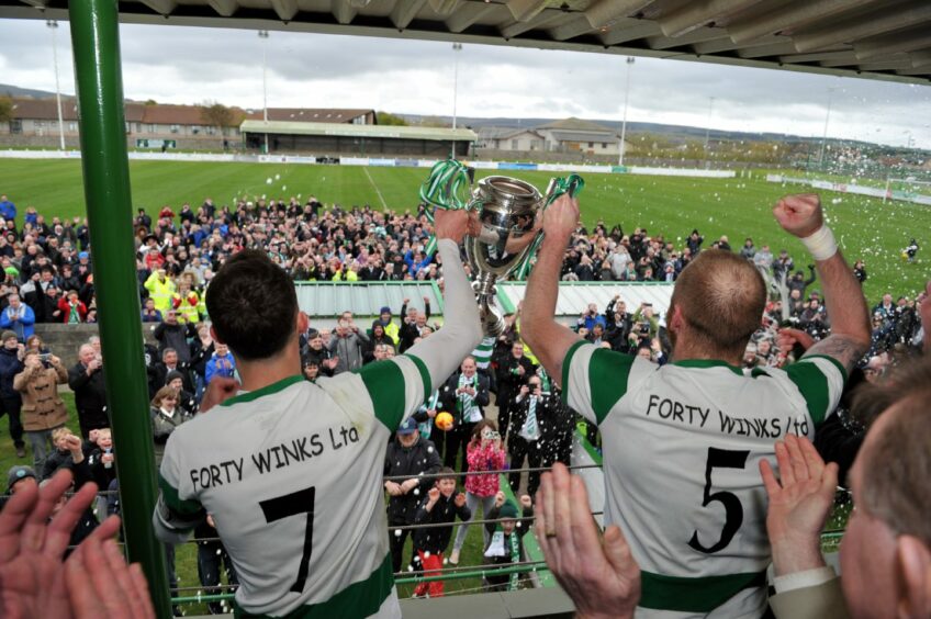 Players and fans celebrate Highland League Cup victory.