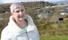 Marri Malloy, chairwoman of Oban Community Council, photographed on Morvern Hill with the care home behind.