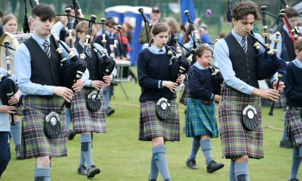 The school's pipe band leads the contestants onto the field. Photo: Sandy McCook/DCT Media.