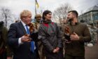 Prime Minister Boris Johnson and President of Ukraine Volodymyr Zelensky, talking to a woman during his visit to Kyiv the Ukrainian capital. 09/04/22 Ukraine Government/PA Wire