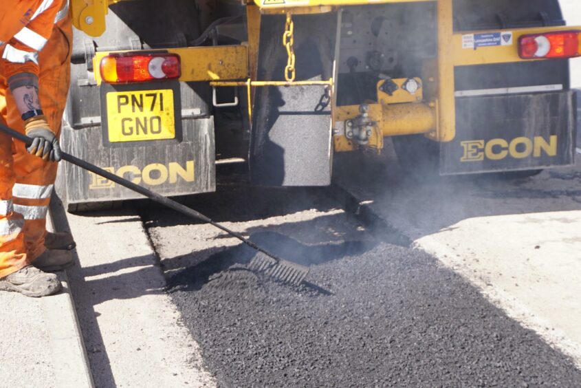 New tar being laid on the road