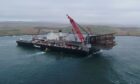 Lerwick, Shetland: Pioneering Spirit, the world's largest construction vessel,
arrives in Dales Voe with the 8,500 tonne Ninian Northern jacket for decommissioning. Photo: Rory Gillies/Shetland Flyer Aerial Media.