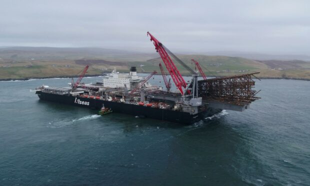 Lerwick, Shetland: Pioneering Spirit, the world's largest construction vessel,
arrives in Dales Voe with the 8,500 tonne Ninian Northern jacket for decommissioning. Photo: Rory Gillies/Shetland Flyer Aerial Media.
