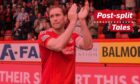 Russell Anderson applauds the fans on his final appearance for the Dons