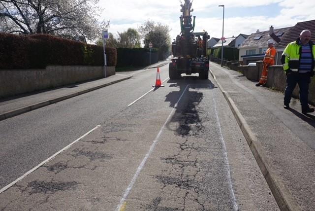 Highland pothole machine repairs a road
