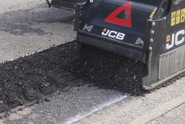 Highland pothole machine repairs a road