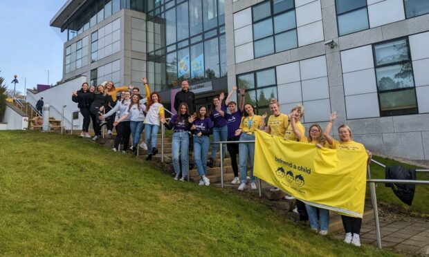 Picture shows: Students of RGU standing in a line on campus.