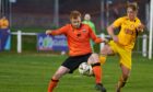 Rothes' Greg Morrison, left, and Ethan Cairns of Fort William battle for possession