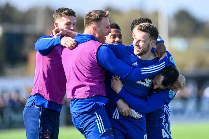 Mitch Megginson is mobbed by Cove Rangers team-mates