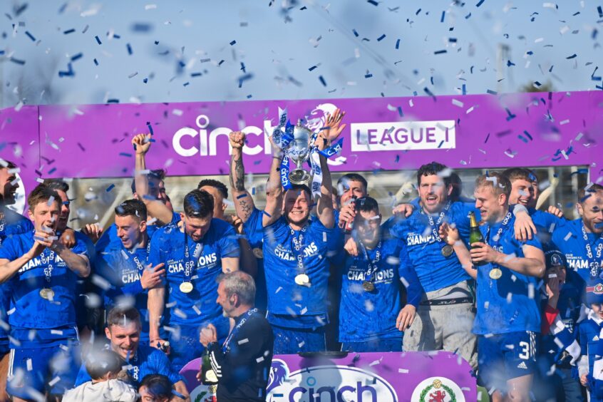 Cove Rangers captain Mitch Megginson lifts the League One trophy