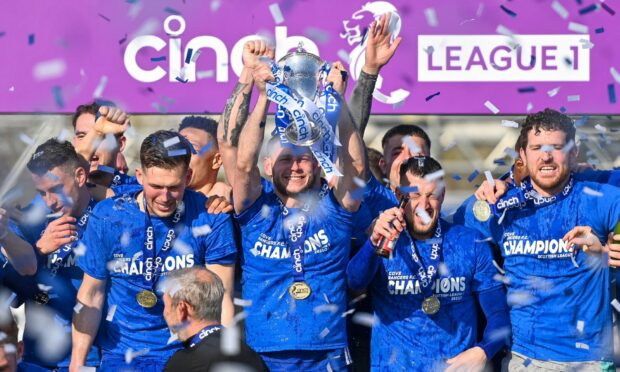 Cove Rangers captain Mitch Megginson lifts the League One title