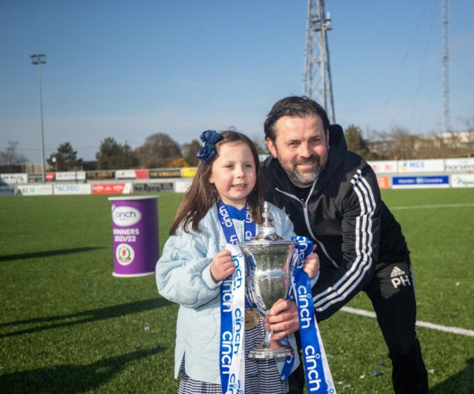 Cove Rangers manager Paul Hartley celebrates with his daughter after full-time
