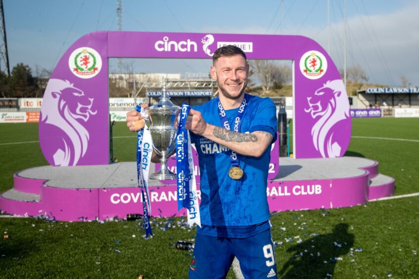 Cove Rangers captain Mitch Megginson with the League One title. Pictures by Scott Baxter