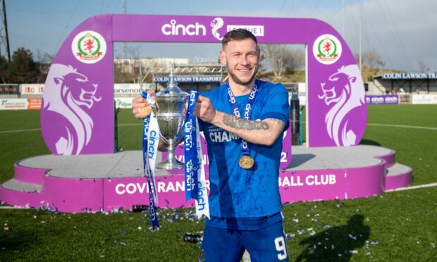 Cove Rangers captain Mitch Megginson with the League One title. Pictures by Scott Baxter