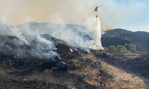 Helicopter dousing the wildfire at Kyle of Lochalsh. Supplied by Spean Bridge CRU