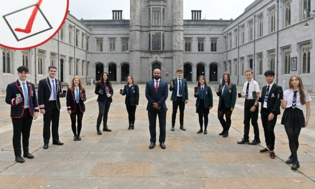 Councillor M. Tauqeer Malik with Aberdeen pupils receiving their results in 2021.