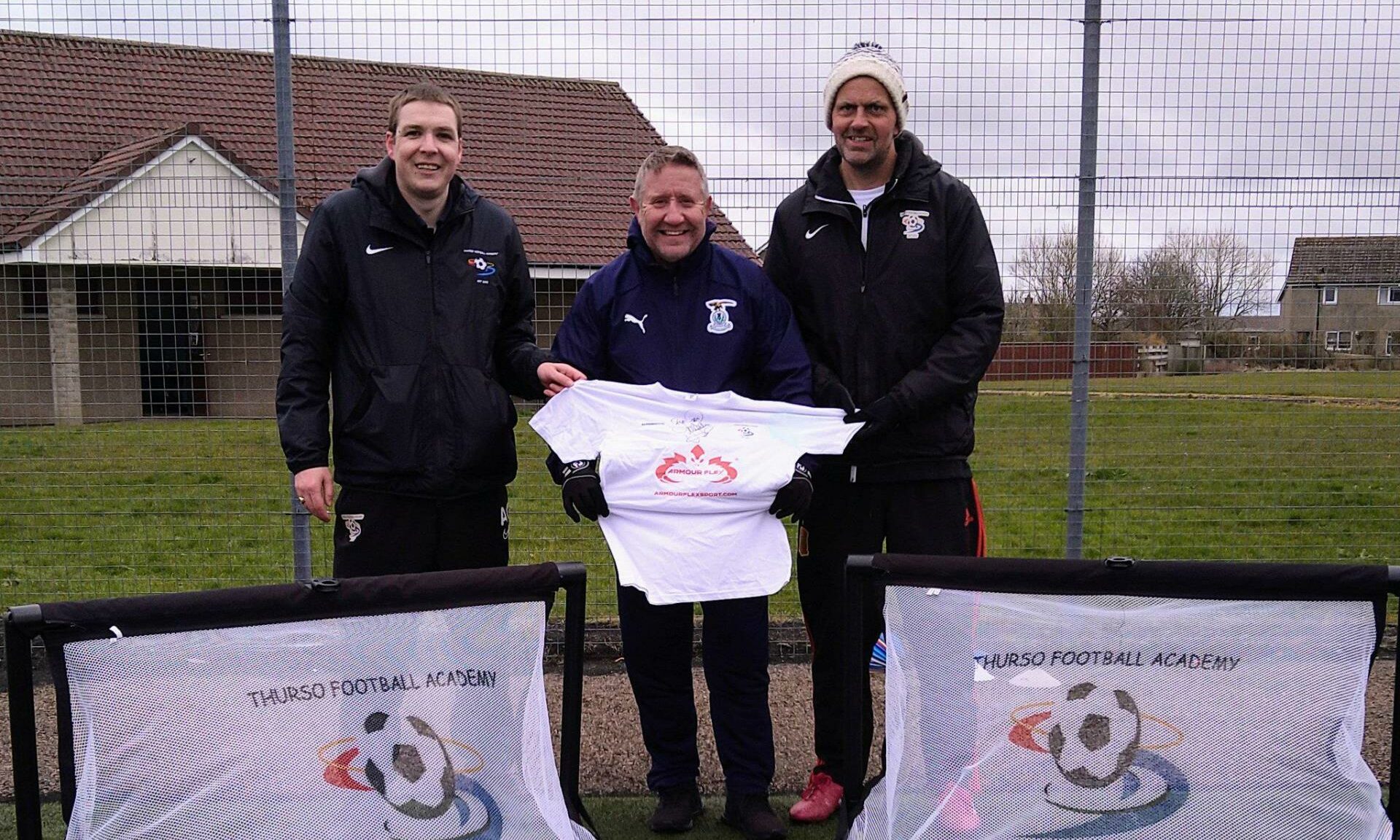 Caley Thistle sporting director John Robertson with Thurso Football Academy's Alyn Gunn and Richie Campbell.