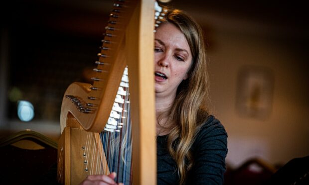 Mary Page plays the harp at Project Sing, a music therapy session for stroke survivors in Aberdeen. Picture by Wullie Marr.