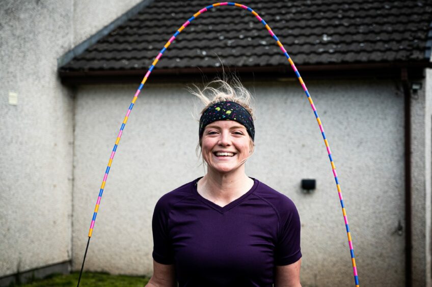 Tamsin Gray with skipping rope over her head. 