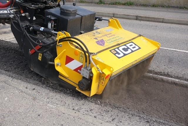 JCB pothole repair machine in action