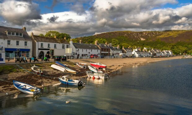 The village of Ullapool with an old fishing boat on the shore