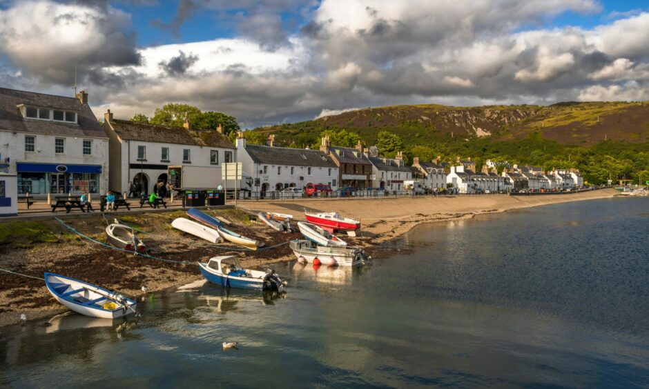 The village of Ullapool with an old fishing boat on the shore