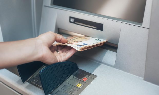 The money was stolen as a woman withdrew it from a cash machine. Image: Shutterstock