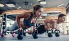 Young couple is working out at gym