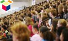 A crowded high school assembly illustrating school capacity issues
