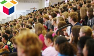 A crowded high school assembly illustrating school capacity issues