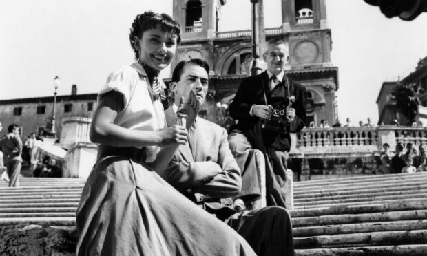 Audrey Hepburn, Gregory Peck and director William Wyler during the filming of Roman Holiday. Photo by Augusto Digiovanni/Paramount/Kobal/Shutterstock