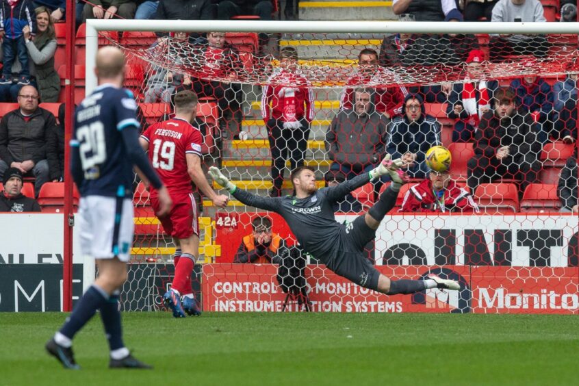 Aberdeen's Lewis Ferguson nets the winner against Dundee from the penalty spot.