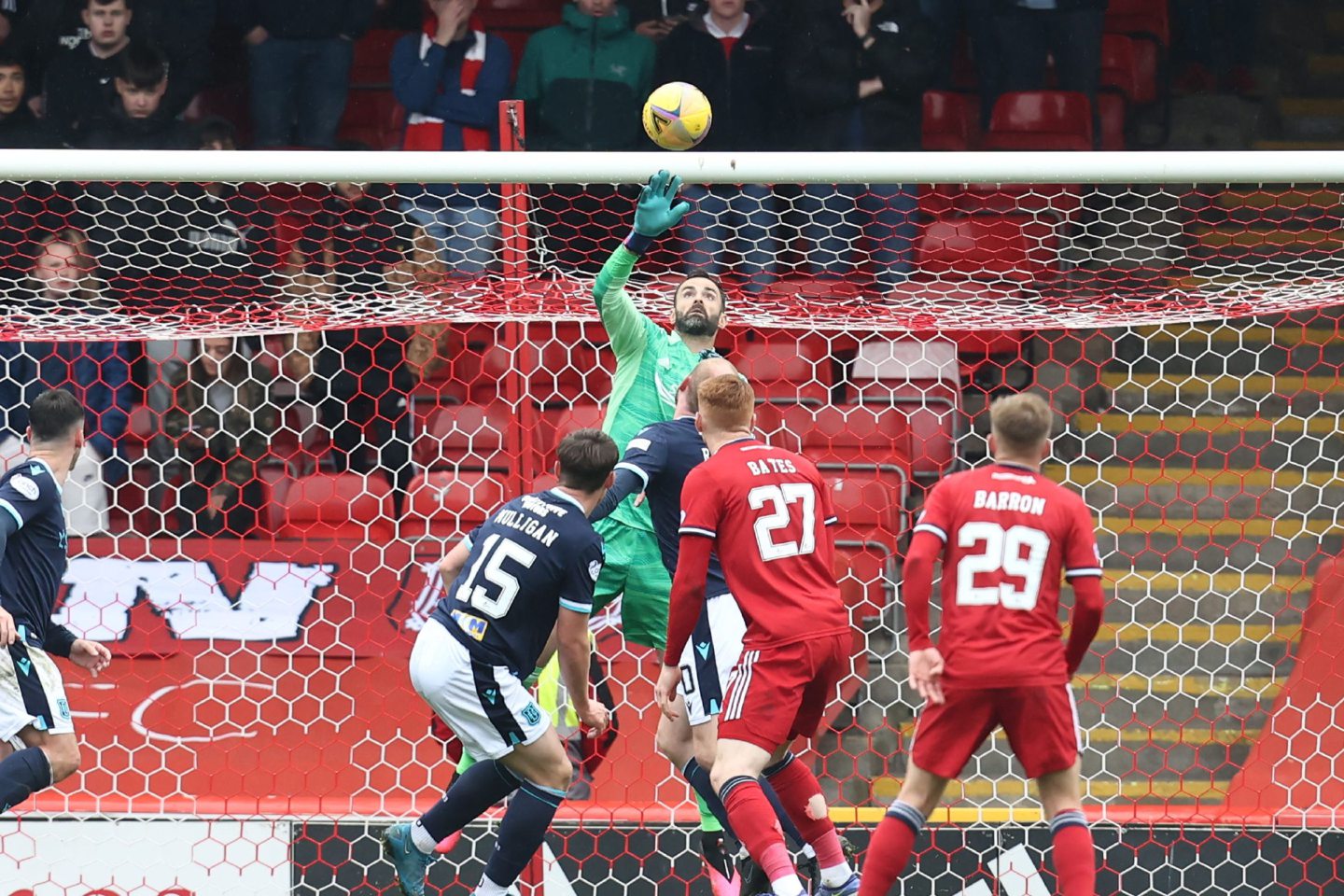 Aberdeen's Joe Lewis saves a shot from Dundee's Josh Mulligan.
