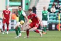 Aberdeen's Dante Polvara  and Joe Newell of Hibs in action in the 1-1 draw.