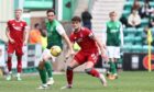 Aberdeen's Dante Polvara  and Joe Newell of Hibs in action in the 1-1 draw.