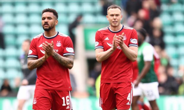 Aberdeen's Andrew Considine (4) and Aberdeen's Funso-King Ojo (16) applaud the fans after the 1-1 draw at HIbs.