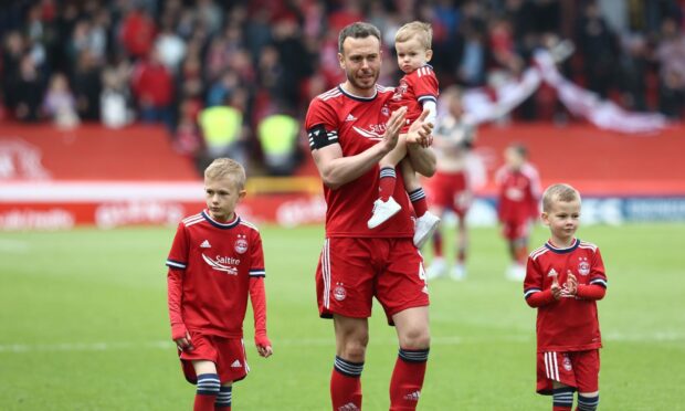 Aberdeen's Andy Considine (4) applauds the fans as he leaves the Pittodrie pitch for the last time.